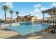 Community pool with lounge chairs, umbrellas, and well-maintained landscaping at 20747 E Arroyo Verde Dr, Queen Creek, AZ 85142