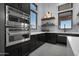 Modern kitchen featuring stainless steel appliances, dark cabinetry, and large windows at 20747 E Arroyo Verde Dr, Queen Creek, AZ 85142