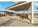 Outdoor patio featuring comfortable seating under a shaded pergola, great for relaxing at 20747 E Arroyo Verde Dr, Queen Creek, AZ 85142