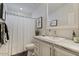 Cozy bathroom features a vanity with marble countertop and a shower with curtain at 2206 S Ellsworth Rd # 160B, Mesa, AZ 85209