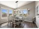 Bright dining room with modern lighting fixture, dining table, and backyard views, perfect for Gathering meals at 2206 S Ellsworth Rd # 160B, Mesa, AZ 85209