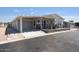 Charming single-story home with covered porch and attached carport, offering comfort and convenience at 2206 S Ellsworth Rd # 160B, Mesa, AZ 85209