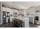 Modern kitchen features stainless steel appliances, white cabinetry, and a marble island with barstool seating at 2206 S Ellsworth Rd # 160B, Mesa, AZ 85209