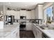 Well-lit kitchen featuring stainless steel appliances, marble countertops, and white cabinets at 2206 S Ellsworth Rd # 160B, Mesa, AZ 85209