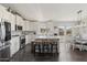 Bright kitchen with stainless steel appliances, white cabinets, marble counters, and an island with stools at 2206 S Ellsworth Rd # 160B, Mesa, AZ 85209