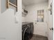 Well-lit laundry room with modern washer and dryer, shelving, and outdoor access at 2206 S Ellsworth Rd # 160B, Mesa, AZ 85209