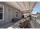 Back patio featuring woven rocking chairs and a retractable sunshade at 2206 S Ellsworth Rd # 160B, Mesa, AZ 85209