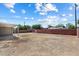 Spacious backyard with block fence and covered patio, offering privacy and shade at 2223 E Roma Ave, Phoenix, AZ 85016