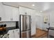 Modern kitchen boasts stainless steel appliances, contrasting cabinets, and wood floors at 2223 E Roma Ave, Phoenix, AZ 85016