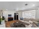 Bright living room featuring hardwood floors, a comfortable couch, and natural light at 2223 E Roma Ave, Phoenix, AZ 85016