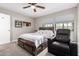 Bedroom features a bed with a decorative headboard and ceiling fan at 225 W 1St St # 107, Mesa, AZ 85201
