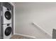 The modern laundry area includes stacked washer and dryer units for convenience and space saving at 225 W 1St St # 107, Mesa, AZ 85201