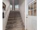 Carpeted staircase leading to the upper level with natural light at 225 W 1St St # 107, Mesa, AZ 85201