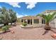 Beautiful backyard showcasing a covered patio, desert landscaping, and a peaceful outdoor retreat at 23309 N Las Positas Ct, Sun City West, AZ 85375