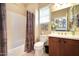 Functional bathroom includes a shower with curtain, vanity, and stylish decor at 23309 N Las Positas Ct, Sun City West, AZ 85375