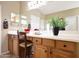 Bathroom view with long countertop, cherry cabinets, and a chair at 23309 N Las Positas Ct, Sun City West, AZ 85375