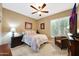 Neutral colored bedroom with ceiling fan, bed, and window at 23309 N Las Positas Ct, Sun City West, AZ 85375