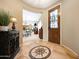 Inviting entryway with decorative tile flooring, glass door, and arched entry into the living spaces at 23309 N Las Positas Ct, Sun City West, AZ 85375