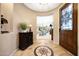 Inviting entryway with decorative tile flooring, glass door, and arched entry into the living spaces at 23309 N Las Positas Ct, Sun City West, AZ 85375