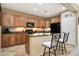 Modern kitchen featuring wood cabinets, a center island, and upgraded appliances at 23309 N Las Positas Ct, Sun City West, AZ 85375