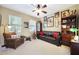 Cozy living room featuring neutral tones, comfortable seating, and personal decor touches at 23309 N Las Positas Ct, Sun City West, AZ 85375