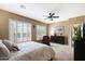 This is a main bedroom with white-trimmed windows, neutral colored walls, and carpeted floors at 23309 N Las Positas Ct, Sun City West, AZ 85375