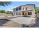 Backyard with a covered patio, block fence, gravel landscaping, and large windows at 29475 N Candlewood Dr, San Tan Valley, AZ 85143