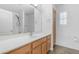 Bright bathroom featuring a white sink, wood cabinets, and a shower with black fixtures at 29475 N Candlewood Dr, San Tan Valley, AZ 85143
