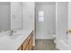 Bright bathroom featuring a toilet, window with shutters, wood cabinets, and a white sink at 29475 N Candlewood Dr, San Tan Valley, AZ 85143