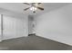 Bright bedroom with carpet, ceiling fan, and a closet at 29475 N Candlewood Dr, San Tan Valley, AZ 85143