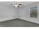Bedroom features neutral walls, carpet, ceiling fan, and a window at 29475 N Candlewood Dr, San Tan Valley, AZ 85143