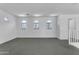 Bonus room offers plenty of space with neutral walls, carpet, and arched windows at 29475 N Candlewood Dr, San Tan Valley, AZ 85143