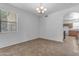 Dining room features a chandelier, large window, and seamless flow to the kitchen at 29475 N Candlewood Dr, San Tan Valley, AZ 85143