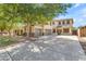 Spacious two-story home with a three-car garage and desert landscaping, perfect for Gathering living at 29475 N Candlewood Dr, San Tan Valley, AZ 85143