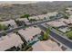 Aerial view of this desert community featuring stucco homes with tile roofs, a green space and mountain views at 3102 E Desert Broom Way, Phoenix, AZ 85048