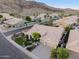 Aerial view of a home with tile roof and well maintained landscaping in a community surrounded by mountains at 3102 E Desert Broom Way, Phoenix, AZ 85048