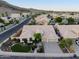 Stunning aerial view of a single-story home featuring lush landscaping, a tile roof, and a two-car garage at 3102 E Desert Broom Way, Phoenix, AZ 85048