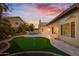 Expansive backyard with a putting green, rock waterfall, and mature landscaping at 3102 E Desert Broom Way, Phoenix, AZ 85048