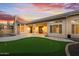 Stunning outdoor space featuring a pool with rock feature, a putting green, and covered porch at 3102 E Desert Broom Way, Phoenix, AZ 85048