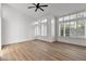 Bright, airy bedroom featuring hardwood floors, ceiling fan, and shuttered windows at 3102 E Desert Broom Way, Phoenix, AZ 85048