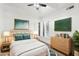 Bright bedroom features a ceiling fan, shuttered windows, neutral walls, and stylish decor for a peaceful retreat at 3102 E Desert Broom Way, Phoenix, AZ 85048