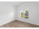 Empty bedroom featuring a fan, arched shuttered windows, and light hard wood floors at 3102 E Desert Broom Way, Phoenix, AZ 85048