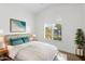 Bright bedroom features a modern ceiling fan, arched shuttered windows, and stylish decor for a peaceful retreat at 3102 E Desert Broom Way, Phoenix, AZ 85048
