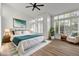 Bright bedroom with ceiling fan, shuttered windows, a large bed, and ample natural light at 3102 E Desert Broom Way, Phoenix, AZ 85048