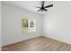 This bedroom features wood-look floors, plantation shutters and a ceiling fan at 3102 E Desert Broom Way, Phoenix, AZ 85048