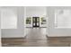 Elegant entryway with wood-look floors, views to the backyard, and decorative black double doors at 3102 E Desert Broom Way, Phoenix, AZ 85048