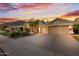 A well-maintained home featuring a spacious driveway and a three-car garage at 3102 E Desert Broom Way, Phoenix, AZ 85048