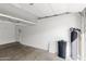 A clean, well-lit two car garage with a water softener and overhead storage racks at 3102 E Desert Broom Way, Phoenix, AZ 85048