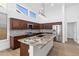 Modern kitchen with a center island, granite countertops, stainless steel appliances, and wood-look floors at 3102 E Desert Broom Way, Phoenix, AZ 85048