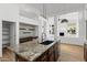 Island boasts granite counters, black sink, stainless dishwasher, and pendant lighting at 3102 E Desert Broom Way, Phoenix, AZ 85048